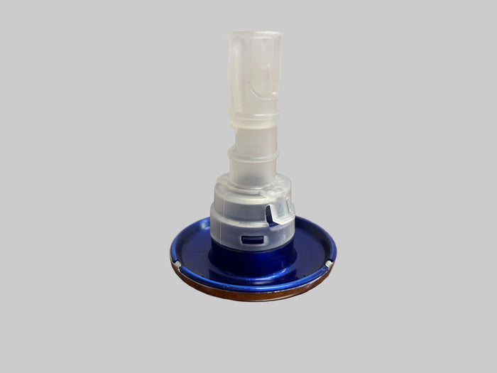 A clear plastic mouthpiece connector with a blue base, resting on a wooden tabletop against a plain light gray wall.