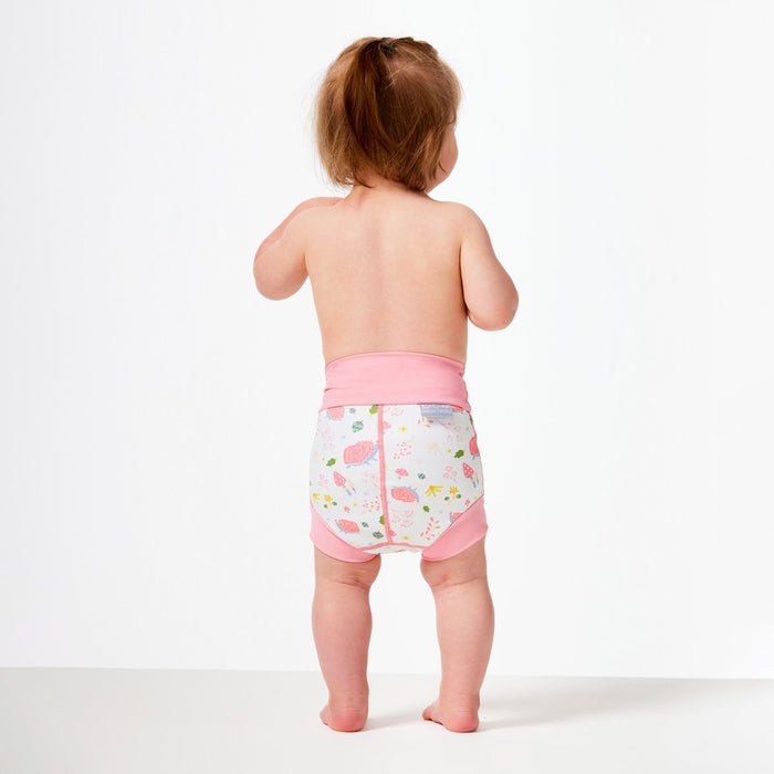 Lifestyle image of little one wearing swim nappy, back.