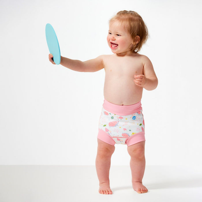 Lifestyle image of little one wearing swim nappy, front.