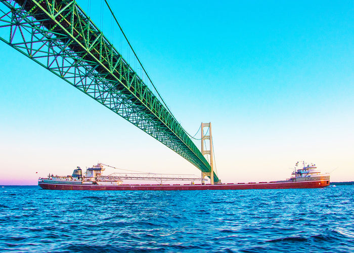 This unique perspective of a freighter traveling beneath the Mackinac Bridge by Jennifer Wohletz of Mackinac Memories evokes a sense of wonder at the bridge's strength and regional importance. &nbsp;The Mighty Mac spans across the Great Lakes to connect Michigan's upper and lower peninsulas.