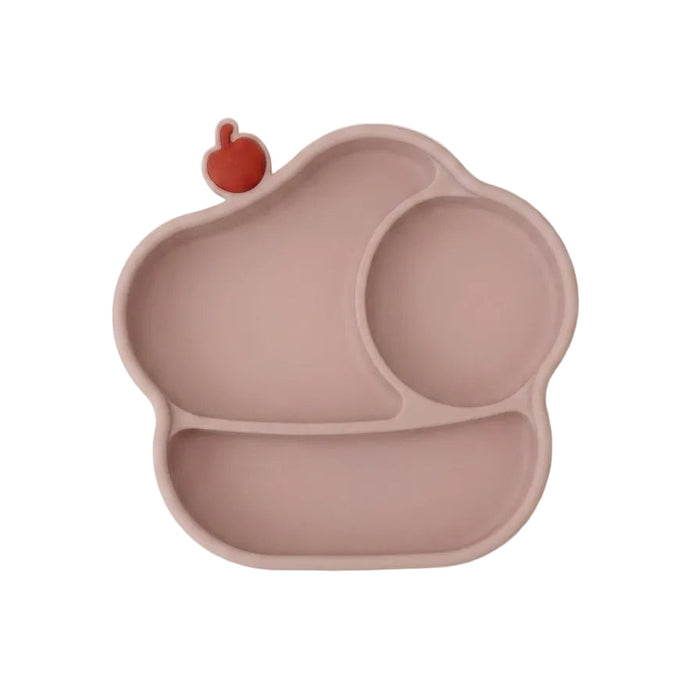 A silicone baby plate in a dusty rose pink color, featuring three compartments and a small red apple-shaped accent on the top left edge, shown against a plain white background.