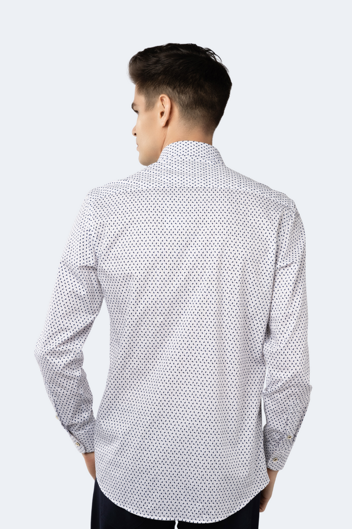Man wearing a white shirt with black geometric pattern on a white background