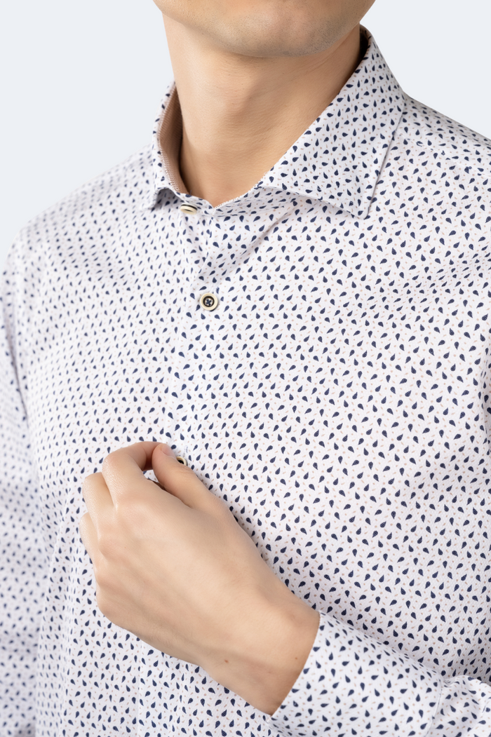 Close-up of a person wearing a white shirt with black geometric pattern