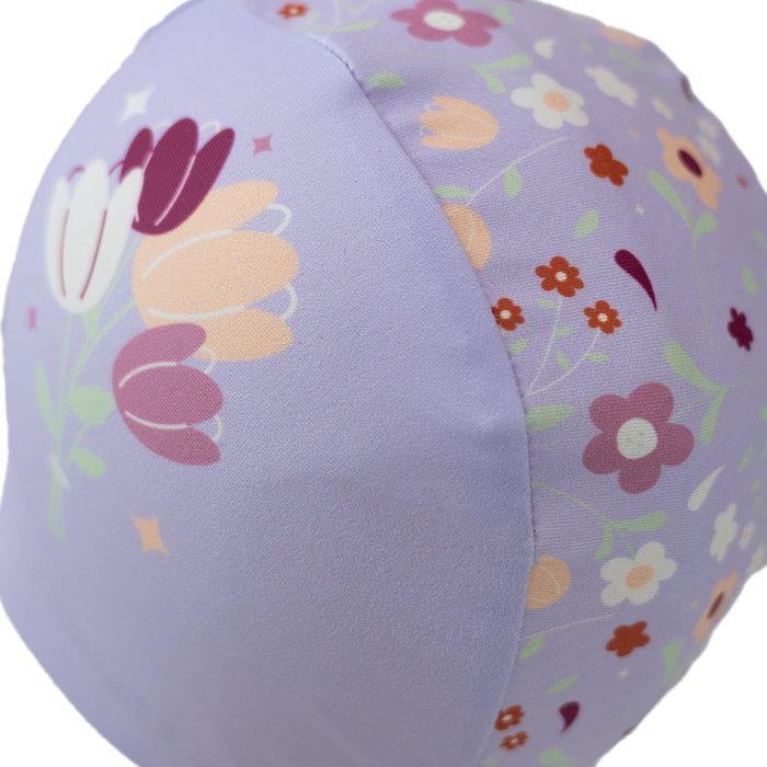 Baby swim hat in lilac featuring floral themed print.