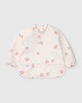 Loulou Lollipop Long Sleeve Bib in Pink Seashells — front view on white background