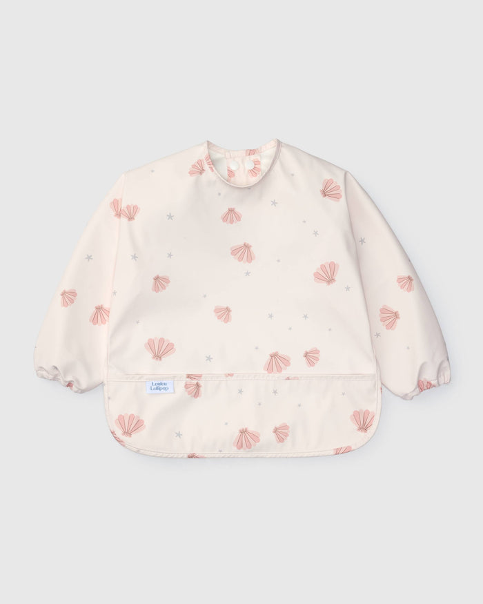 Loulou Lollipop Long Sleeve Bib in Pink Seashells — front view on white background