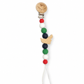 A wooden pacifier clip with colorful silicone beads in red, white, green, and navy, featuring a small wooden bird charm and a white cord, shown on a plain white background.