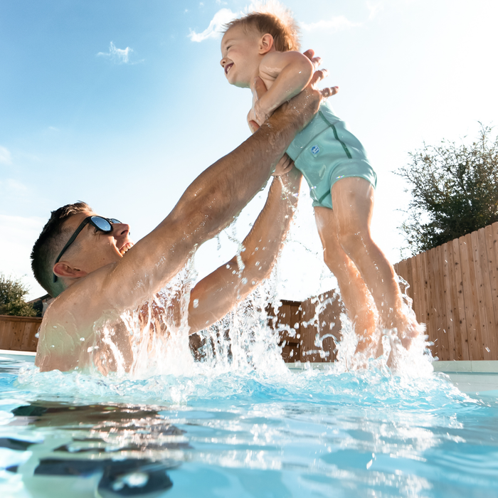 Child wearing reusable swim diaper in the pool.