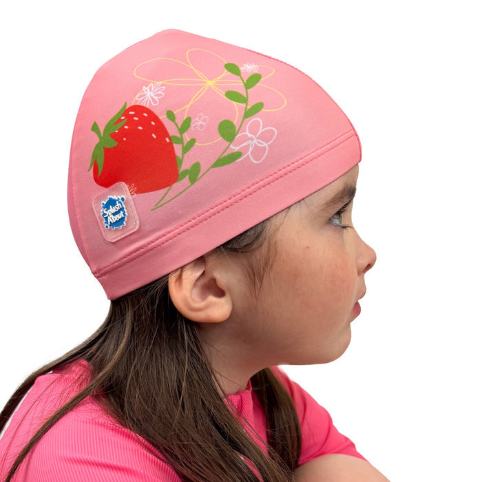 Baby swim hat in pink featuring strawberries themed print.