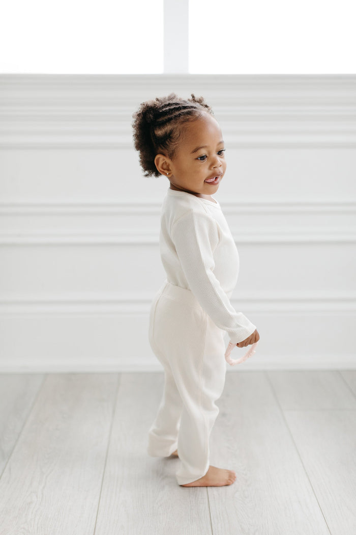 Loulou Lollipop Waffle Long Sleeve Bodysuit in Coconut Milk — front view on white background