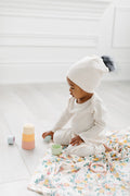 Loulou Lollipop Waffle Pom Pom Hat in Coconut Milk — front view on white background