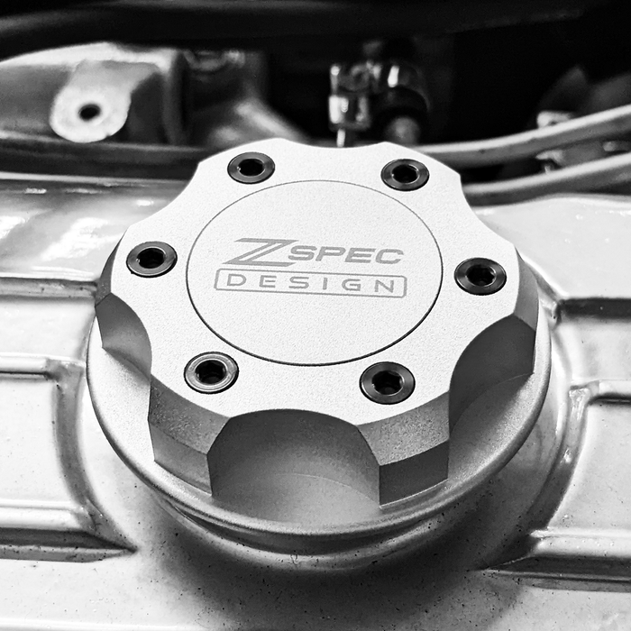 Silver ZSPEC Billet Oil Filler Cap with titanium accents for Nissan, Infiniti, and Datsun engines, showcasing durable hardware fastener design.