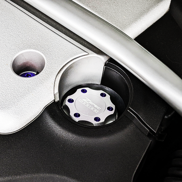 Silver ZSPEC Billet Oil Filler Cap with titanium accents and blue bolts for Nissan, Infiniti, and Datsun vehicles.